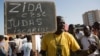 A protester carries a sign reading "Zida is Judas Iscariot," referring to coup leader Lt. Col. Yacouba Isaac Zida, in Ouagadougou, capital of Burkina Faso, Nov. 2, 2014. 
