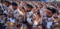 FILE - Members of Iran's Revolutionary Guards Corps (IRGC) march during the annual military parade marking the anniversary of the outbreak of the devastating 1980-1988 war with Saddam Hussein's Iraq, in the capital Tehran, Sept. 22, 2018.