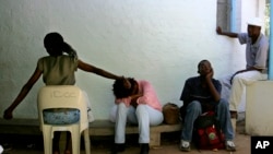FILE - HIV patients wait to receive their anti-retroviral medicine at the Deborah Retief hospital in Moshundi, Botswana, Thursday, Nov. 17, 2005.
