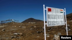 FILE - A signboard is seen from the Indian side of the Indo-China border at Bumla, in the northeastern Indian state of Arunachal Pradesh, Nov. 11, 2009. 