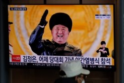 FILE - A man sits in front of a TV screen showing North Korean leader Kim Jong Un, at the Seoul Railway Station in Seoul, South Korea, Jan. 15, 2021, the day after North Korea's parade celebrating a ruling party congress.