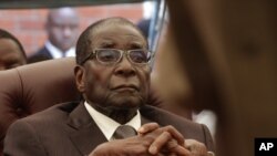 FILE - Zimbabwean President Robert Mugabe attends the funeral of his sister Bridget, in Zvimba, Zimbabwe, Jan. 21, 2014.