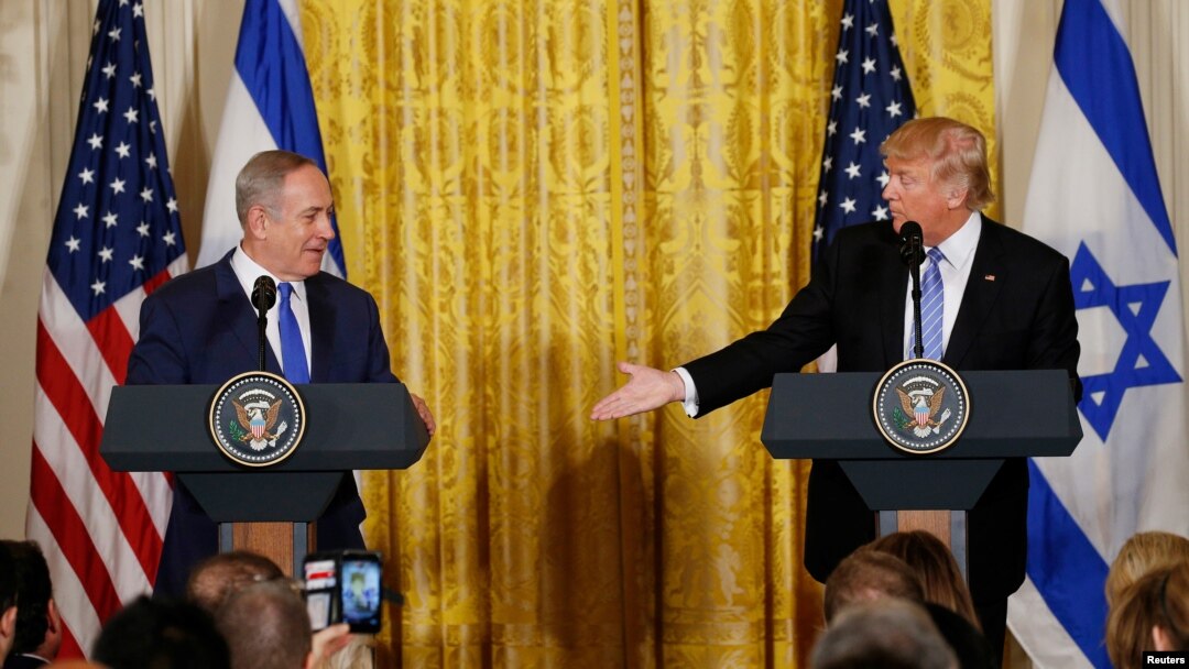 FILE - U.S. President Donald Trump, right, reaches out to Israeli Prime Minister Benjamin Netanyahu during a joint news conference at the White House in Washington, Feb. 15, 2017. 