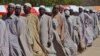 Men who were being detained on suspicion of affiliation to Boko Haram, line up as they are released by the Nigerian military in Maiduguri, Nigeria, July 6, 2015