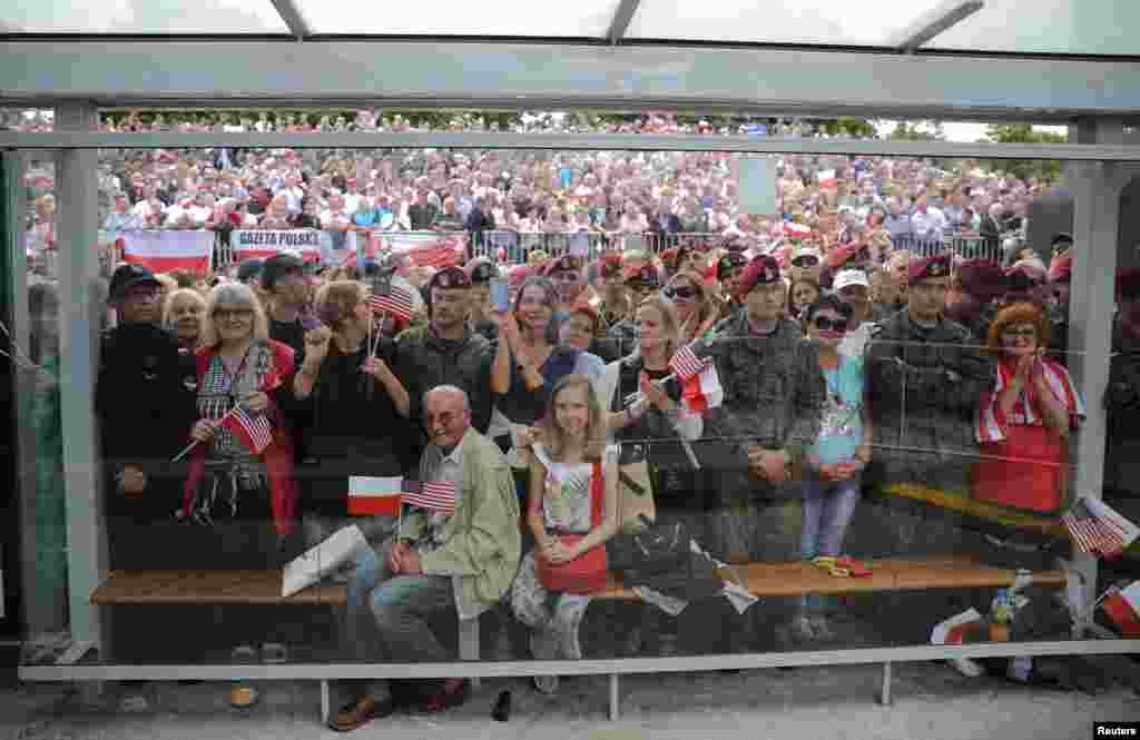 People listen to U.S. President Donald Trump's public speech at Krasinski Square, in Warsaw, July 6, 2017.