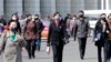 Pedestrians wear face masks to help prevent the spread of the coronavirus, Wednesday, April 1, 2020, in Pyongyang, North Korea. 