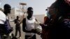 FILE - Faty, from the Village Pilote association, wears a protective face mask during distribution of food to street children amid an outbreak of the coronavirus disease, in Dakar, Senegal, April 1, 2020.