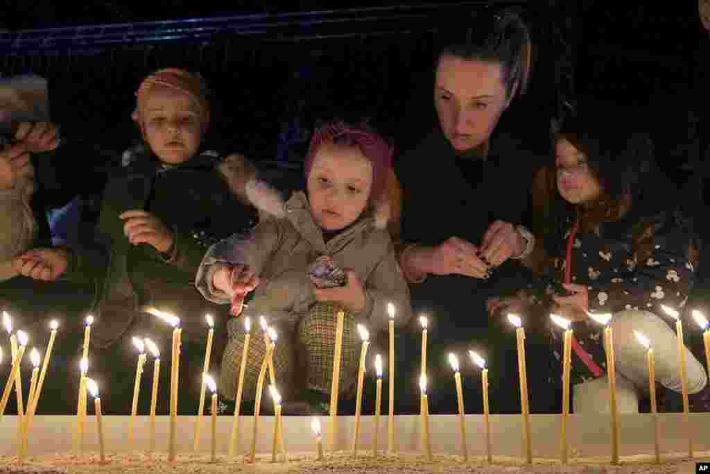 People light candles for the victims of the Wednesday's shooting rampage in Cetinje, in Podogrica, Montenegro, Jan. 2, 2025.
