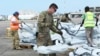 Members of the US army help load supplies at Beira International airport, Mozambique, Monday, April 1, 2019, joining the humanitarian aid efforts following a cyclone that hit the country on March 14. 
