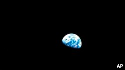 FILE - This Dec. 24, 1968, file photo made available by NASA shows the Earth behind the surface of the moon during the Apollo 8 mission.