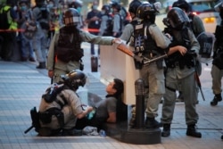 Police detain a protester during a march marking the anniversary of the Hong Kong handover from Britain to China, in Hong Kong, July. 1, 2020.