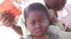 Parents and children in Malawi use health passports as a portable medical record. (Alain HY Cheng)