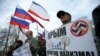 A man holds a banner as he attends a pro-Russian rally at the Crimean parliament building in Simferopol, March 6, 2014.