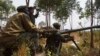 Congolese government army soldiers prepare their weapons at an attack position near Munigi, overlooking the front-line, where they are fighting against M23 rebels outside the eastern Congolese city of Goma, Jul. 15, 2013.