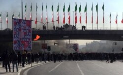 FILE - Smoke rises during a protest after authorities raised fuel prices, in the central city of Isfahan, Iran, Nov. 16, 2019.