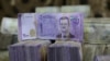 FILE - Syrian pounds are pictured inside an exchange currency shop in Azaz, Syria, Feb. 3, 2020. Rising prices and a drop in the currency's value have pushed ordinary Syrians to vent their anger in recent protests.