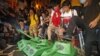 Pro-democracy protesters step on the mock Chinese PLA tanks after tens of thousands people march at a down town street during the annual pro-democracy protest in Hong Kong, July 1, 2012. 