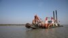 FILE - A dredging machine is seen near the island of Bhasan Char, in the Bay of Bengal, Bangladesh. Feb. 14, 2018. 