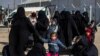 Women and children are seen in the Kurdish-run al-Hol camp which holds suspected relatives of Islamic State (IS) group fighters, in Hasakeh governorate in northeastern Syria, Jan. 28, 2021.