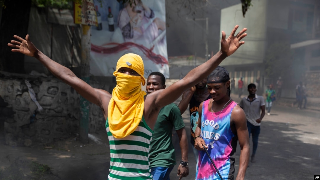 People protest against the assassination of Haitian President Jovenel Moïse near the police station of Petion Ville in Port-au-Prince, Haiti, July 8, 2021.