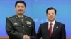 Chinese Defense Minister Chang Wanquan, left, poses with his South Korean counterpart, Han Min-goo, for photographers prior to a meeting at the Defense Ministry in Seoul, Feb. 4, 2015.
