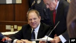 Harvey Weinstein, left, and his attorney Benjamin Brafman talk in court, in New York, July 9, 2018.