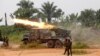 FILE - Democratic Republic of Congo soldiers are seen launching missiles during their military operation against ADF rebels outside the town of Beni, in North Kivu province, Jan. 18, 2014.