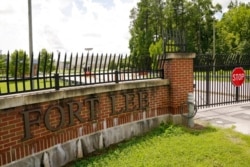 FILE - A sign marks an entrance to U.S. Army base Fort Lee, Aug. 17, 2021, in Petersburg, Va. Afghan refugees who have been prescreened by the U.S. Department of Homeland Security have been taken to Fort Lee and other temporary reception centers.