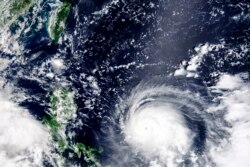 Citra satelit yang dirilis NASA, Topan Chanthu (kanan) berkembang menjadi topan kuat yang bergerak menuju Taiwan (kiri atas), Kamis, 9 September 2021.