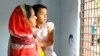 Nasima Akhter holds daughter Arwa, 6, at the main gate of their home in Dhaka, Bangladesh. Akhter’s husband, Sajedul Islam Shumon, disappeared into undisclosed detention in 2013. (A. Rajjak for VOA)