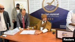 Saif al-Islam al-Gadhafi, son of Libya's former leader Moammar al-Gadhafi, registers as a presidential candidate for the December 24 election, at the registration center in the southern town of Sebha, Nov. 14, 2021. 