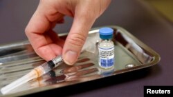 FILE - A vial of the measles, mumps, and rubella virus (MMR) vaccine is pictured at the International Community Health Services clinic in Seattle.