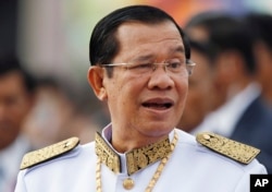 FILE - Cambodia's Prime Minister Hun Sen waits to attend Independence Day celebrations in Phnom Penh, Cambodia, Nov. 9, 2017.