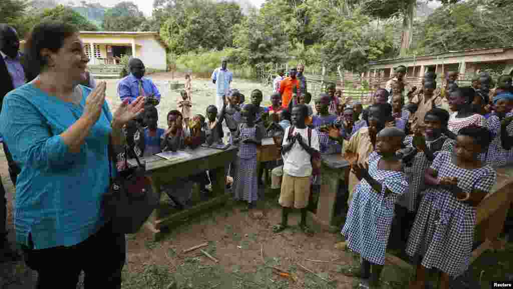 Students welcome United Nations Children's Fund (UNICEF) Ivory Coast Representative Adele Khudr as she arrives for a Ebola awareness drive in Gueupleu, Man, in western Ivory Coast, Nov. 3, 2014.