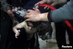 FILE - A child is treated in a hospital in Douma, eastern Ghouta in Syria, after what a Syria medical relief group claims was a suspected chemical attack April 7, 2018.