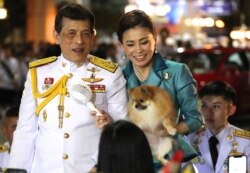 Thai King Maha Vajiralongkorn, left, and Queen Suthida meet supporters after attending a ceremony to mark an anniversary of the death of King Vajiravudh in Bangkok, Thailand, Nov. 25, 2020.