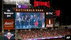 Images of President Donald Trump and first lady Melania Trump, accompanied by Republican lawmakers, are seen on an outfield scoreboard during a Salute to the Military during Game 5 of the World Series in Washington D.C., Oct. 27, 2019.