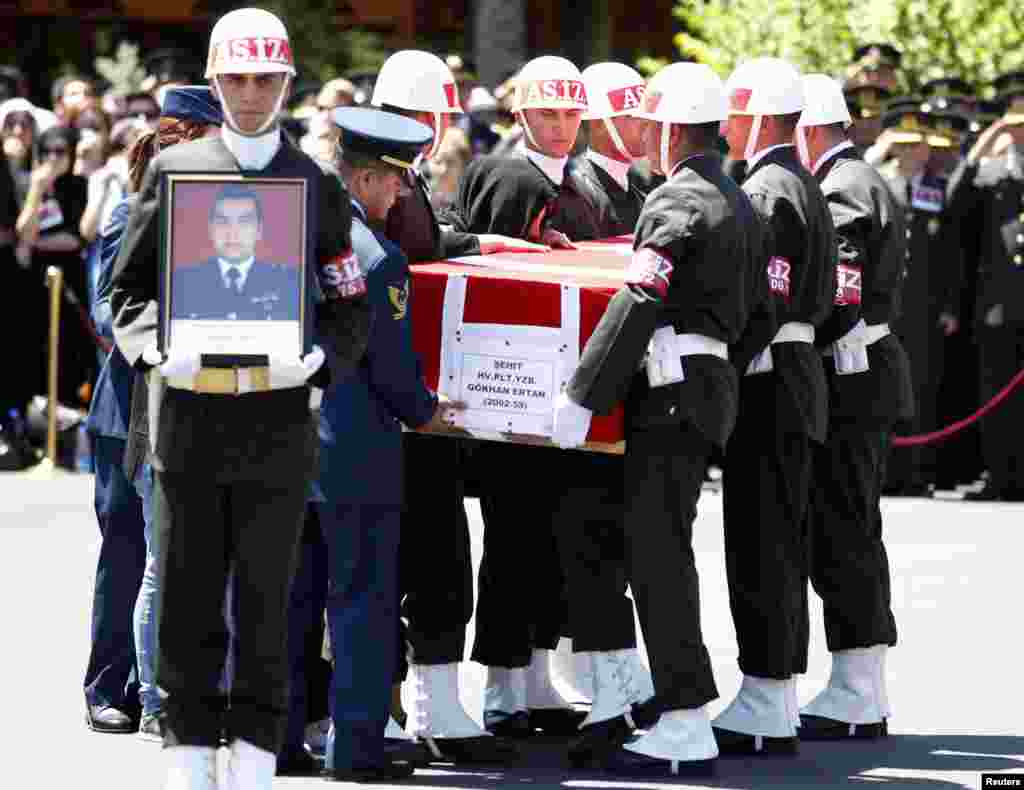 Nihal Ertan, wife of fallen pilot Captain Gokhan Ertan, kisses the coffin of her husband during an official farewell ceremony at the 7th Jet Main Air Base, Malatya, Turkey, July 6, 2012.