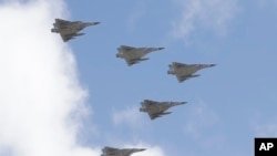 FILE - Taiwan's Mirage 2000 fighter jets fly in close formation over President Office during National Day celebrations in front of the Presidential Building in Taipei, Oct. 10, 2021.