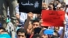 Lebanese protesters hold Arabic placards that read: "#Aleppo," at left, and "Sorry, Aleppo, you are not Paris," at right, during a protest to show solidarity with Aleppo, in Sidon, Lebanon, May 6, 2016. 