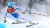 Austria's Matthias Mayer makes a turn in the men's downhill at the Sochi 2014 Winter Olympics, Sunday, Feb. 9, 2014, in Krasnaya Polyana, Russia.