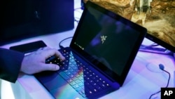 FILE - A laptop is seen in this Jan. 7, 2016, file photo. Royal Jordanian Airlines is advising passengers that laptops, iPads, cameras and other electronics won’t be allowed in carry-on luggage for U.S.-bound flights starting March 21, 2017.