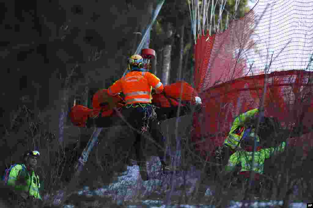 Medical staff transport France's Cyprien Sarrazin after crashing into the protections net during an alpine ski at the men's World Cup downhill training, in Bormio, Italy.