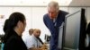Britain's Prince Charles talks to a computer student at the Carlos Rosario International Public Charter School for Adults in Washington, Thursday, March 19, 2015. The school has more than 2,900 students and is tailored to meet the needs of the local immig