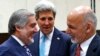 With U.S. Secretary of State John Kerry (C) watching, Afghanistan President Mohammad Ashraf Ghani (R) talks with Afghan Chief Executive Abdullah Abdullah at a NATO foreign ministers meeting in Brussels, Dec. 2, 2014.