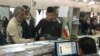 FILE - Afghan refugees submit documents at a refugee center in Tehran, Iran, Oct. 24, 2016. UNHCR estimates that 3 million Afghans are living in Iran.