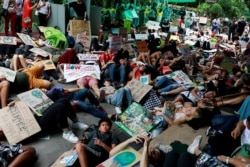 Environmental activists play dead as they participate in a Global Climate Strike near the Ministry of Natural Resources and Environment office in Bangkok, Thailand, Sept. 20, 2019.