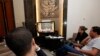 Reporters watch a live feed of Libyan members of parliament meeting to decide on the new prime minister at the parliament in Tripoli, May 4, 2014. 