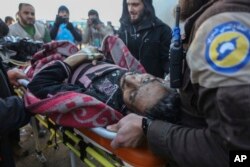FILE - An injured Syrian arrives at a refugee camp in Rashidin, near Idlib, Syria, after he was evacuated from Aleppo during a cease-fire, Dec. 20, 2016.