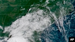 FILE - In this image provided by NOAA, Tropical Storm Gordon approaches the United States on Sept. 4, 2018.